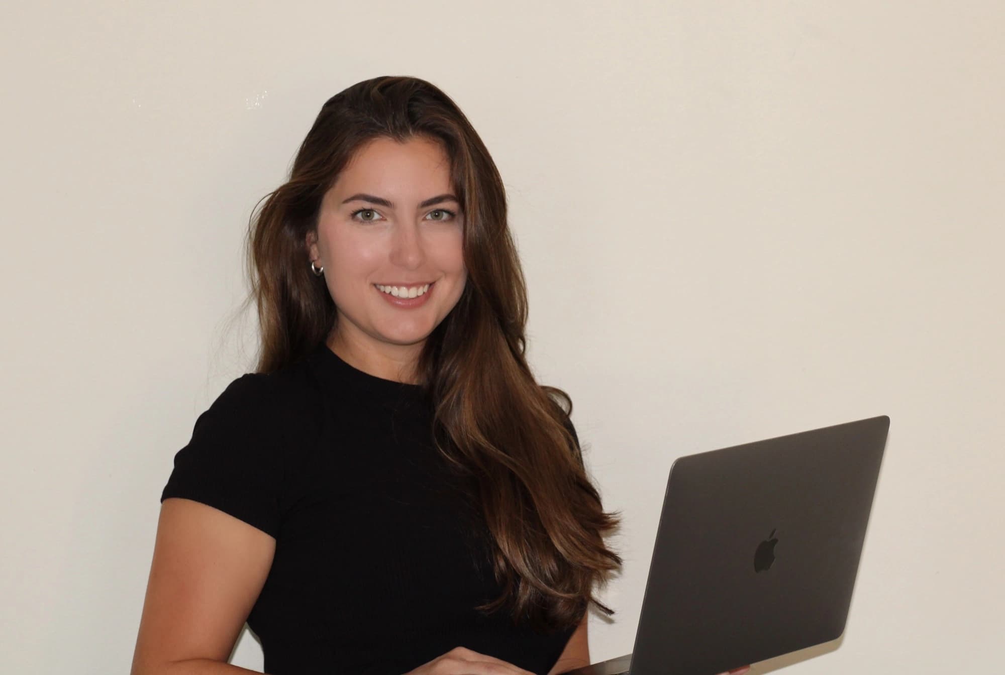 Hope smiling, holding a laptop